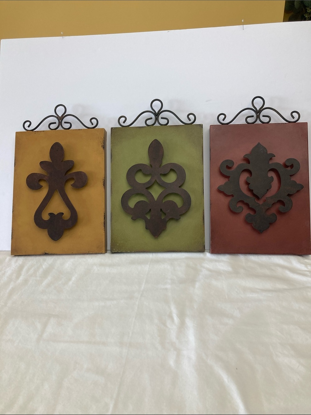 3 Wall Art Plagues with metal on the top and the center.
